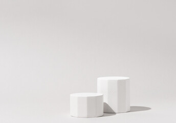 Cosmetics product presentation background scene made with two white pillars podium in sunlight....