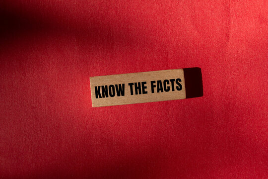 Know the facts message written on wooden block with red background. Conceptual know the facts symbol. Copy space.