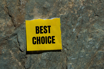 Best choice message written on ripped yellow torn paper piece with stone background. Conceptual best choice symbol. Copy space.