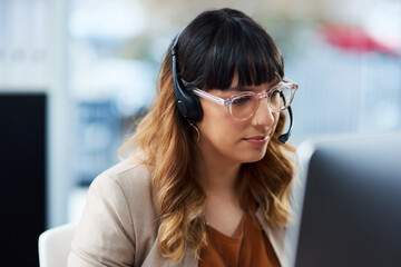 Business woman, computer and phone consultation with customer support and headphones at job. Office, crm and telemarketing consultant with internet advice and help desk assistance with online agent