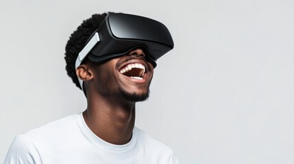 Young man is looking up and laughing while wearing a vr headset and experiencing virtual reality. He is isolated on a white background