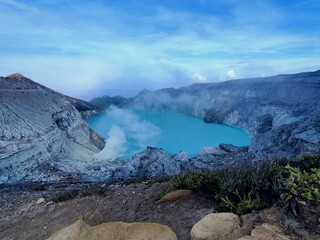 Scenic Ijen Crater with Blue Acidic Lake and Sulfur Mist in Indonesia