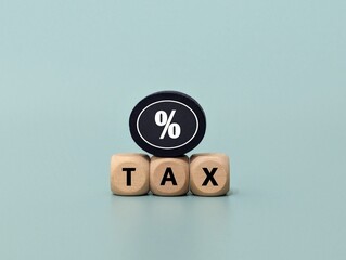 wooden cube with percentage icon and Tax word. Tax concept