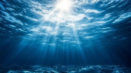 A serene underwater scene showcasing sunlight penetrating the tranquil ocean surface, creating mesmerizing light beams.