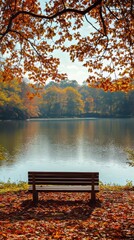 Fototapeta premium Inviting autumn scene with colorful leaves, a serene lake, and an empty bench perfect for relaxation in the peaceful park