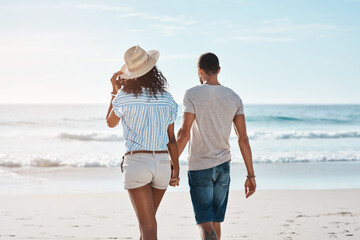Couple, back and holding hands at beach for travel, summer and tropical holiday together in San Diego. Man, woman and walking on sand by ocean for adventure, love and relax on vacation with partner