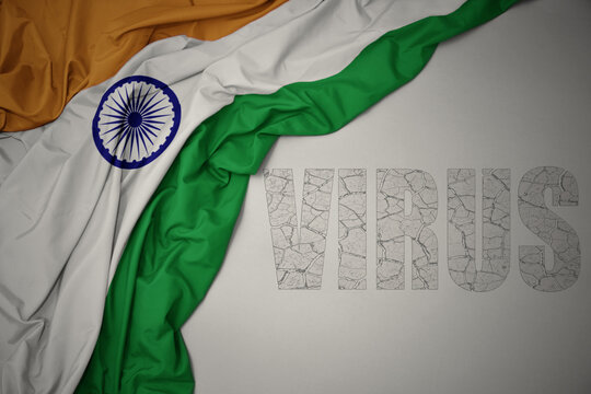 waving colorful national flag of india on a gray background with text virus .
