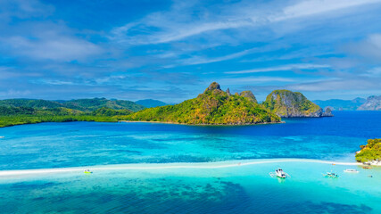 Aerail view of  tropical exotic island sand bar separating sea in two with turquoise  in El Nido, Palawan, Philippines.