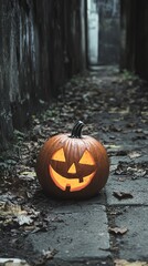 Spooky Halloween pumpkin with a carved face glowing in a dark, narrow alley filled with fallen leaves, creating a creepy atmosphere.