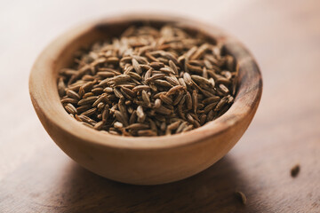 cumin zira seeds in wood bowl on table