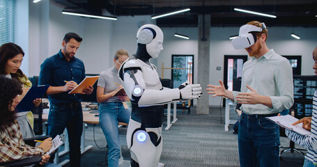Multi-ethnic people completing testing of creation. Checking some moves or hardware configuration...