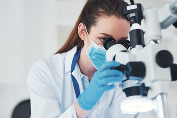 Microscope, scientist and investigation in research laboratory for medicine, biology and...