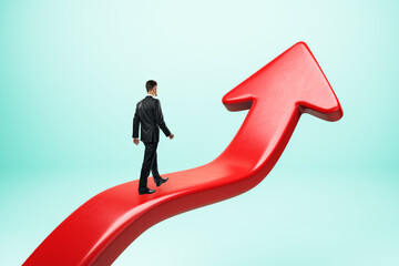 Businessman walking on a large red arrow pointing upward, symbolizing growth and success.