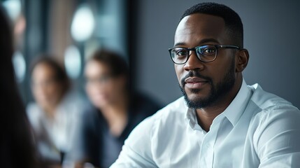 Confident African American male boss leading a diverse team in an office briefing, emphasizing leadership