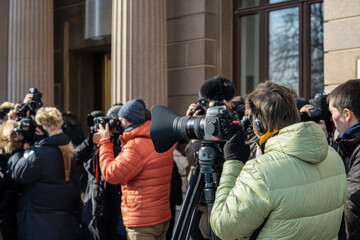 A dynamic scene of reporters and photographers outside a government building, capturing the essence of press freedom and the role of media in democracy on World Press Freedom Day