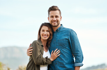 Obraz premium Outdoor, couple and smile on portrait for love on break with bonding, holiday and care in Spain. People, hug and happy or satisfied with vacation to relax, chill and affection with support as lovers