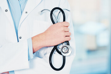 Closeup, hand and doctor in healthcare with stethoscope, lungs assessment and monitoring health by space. Medical, cardiologist and tool to listening for heart sounds, rhythm and person in clinic