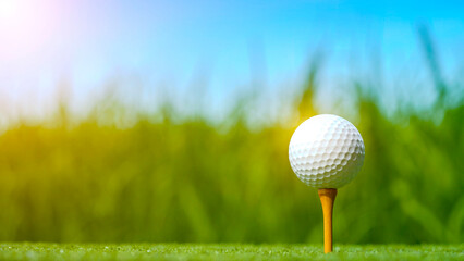 Golf ball on tee in beautiful golf course with sunset.