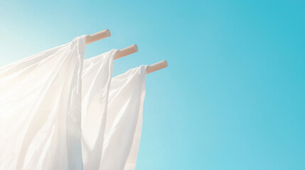 close-up of white laundry fluttering gently in the breeze under a clear blue sky, with warm sunlight adding a touch of brightness, evoking a sense of cleanliness and freshness, pho