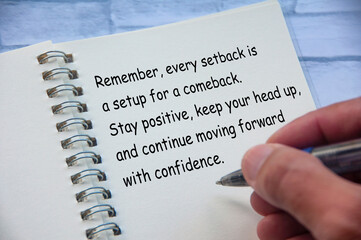 Motivational and inspirational or encouragement quote relating setback and comeback written on...