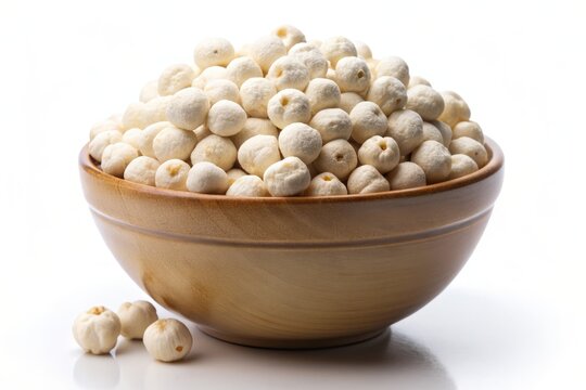 Delicate white crispy lotus seeds, also known as Phool Makhana, overflow from a cream-colored ceramic bowl, isolated on a pure white background, evoking serenity.