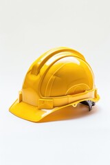 Fototapeta premium A yellow hard hat sits alone on a white surface, ready for use
