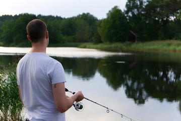 a fishing man staning by blank  sea in white t shirt