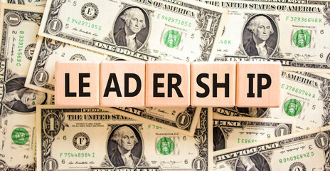 Leadership symbol. Concept word Leadership on beautiful wooden blocks. Dollar bills. Beautiful...