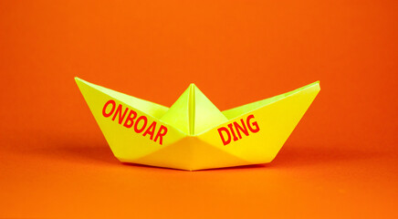 Onboarding success symbol. Concept word Onboarding on beautiful yellow paper boat. Beautiful orange background. Business onboarding success concept. Copy space.