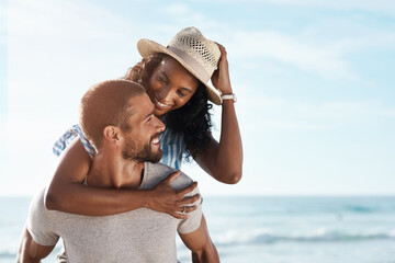 Love, smile and piggyback with couple, beach and happy relationship for anniversary on holiday together. Romance, African man and woman with ocean, summer break and bonding with sunset on vacation