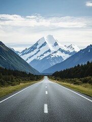 Naklejka premium Scenic highway leading to snow-capped mountains in New Zealand