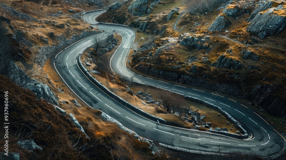 Poster aerial view of a winding mountain road with trees and mountains in the background