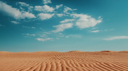 Serene sand dunes under a bright blue sky

