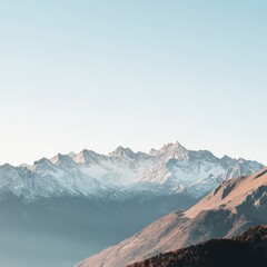 a mountain range with a lake and a mountain in the background