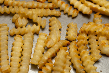 Crinkle cut french fries on a nonstick pan