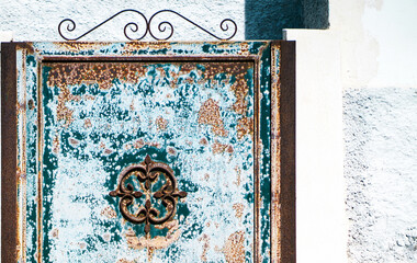 Old vintage door with ornament, details in blue and brown colors.