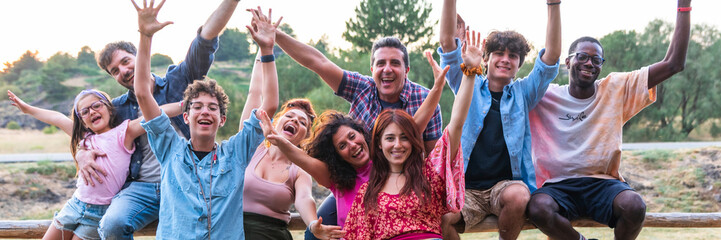 Multiracial group young people having fun in nature – multicultural funky friends hand up - horizontal web banner size for header