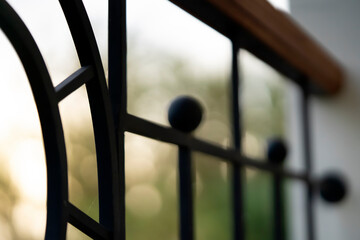 Curved forged modern fence on the balcony closeup.