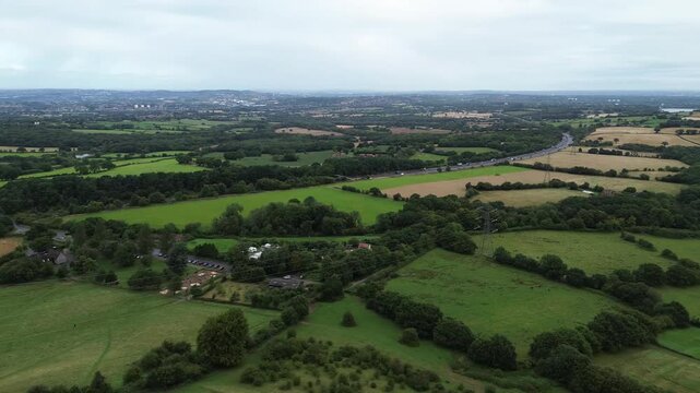 Aerial View of a Motorway cutting through the English Countryside [4K]