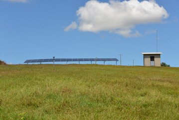 Open space solar panels installation with photovoltaic modules on a hay field in rural farm on...
