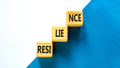 Resilience symbol. Concept word Resilience on beautiful wooden blocks. Beautiful blue and white background. Business resilience concept. Copy space.