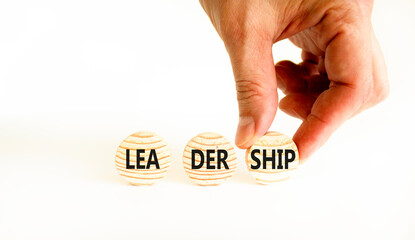 Leadership symbol. Concept word Leadership on beautiful wooden circles. Beautiful white table white background. Businessman hand. Business leadership concept. Copy space.