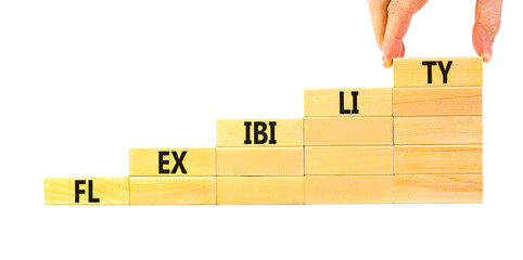 Flexibility symbol. Concept word Flexibility on beautiful wooden blocks. Businessman hand....