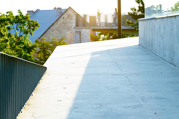 old city balcony view point terrace top building design architecture of concrete geometric shapes in sun light with glare effect and tourists silhouette background taking photo