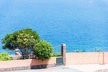 Coastal view near popular tourist destination, town Castelsardo in Sardinia, Italy. Seafront promenade. 