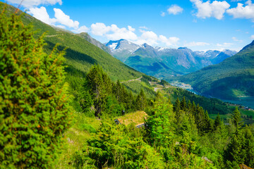 Naklejka premium Nature in fjords. Rakssetra, Norway. Panoramic view. Traveling on a Norwegian fjord. Scandinavia. Traditional old settlement. Houses with moss on the roof. Vacation and travel in summer Norway.