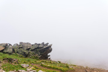 mountain landscape, rocks on a mountainside in thick fog