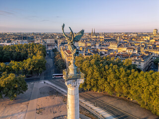 Naklejka na ściany i meble The drone aerial view of The Girondins Monument and Bordeaux city at sunrise. Monument aux Girondins (The Girondins Monument) is a dramatic fountain statue in Bordeaux. 