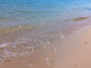 Soft blue ocean wave on fine sandy beach background