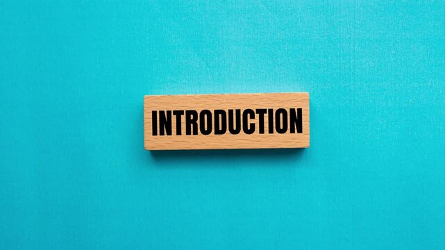 Introduction message writing on wooden block on blue background. Conceptual introduction symbol.